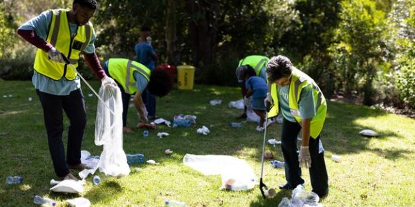 multi-generation-mixed-race-family-spending-time-outside-together-all-wearing-blue-volunteer-t-shirts-protective-gloves-collecting-garbage-holding-garbage-bags-sunny-day_13339-305383