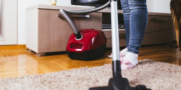 young-woman-cleaning-house-with-vacuum-cleaner_473712-485