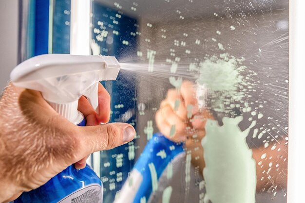 cleaning-bathroom-mirror-with-detergent_511044-3347