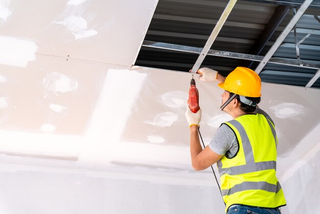 construction-workers-using-electric-drill-are-install-ceiling-house-building-construction-ceiling-installation-ideas_61243-1131