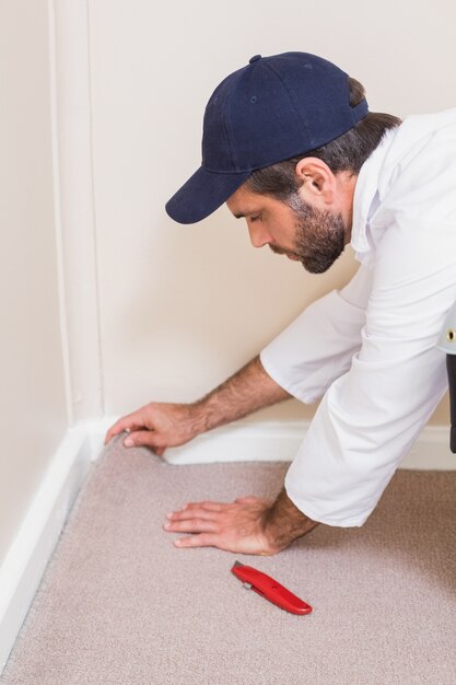 handyman-laying-down-carpet_13339-94179