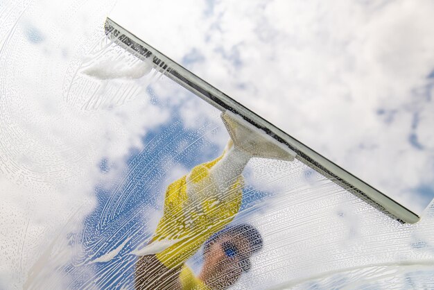 window-cleaner-using-squeegee-wash-window_419829-505